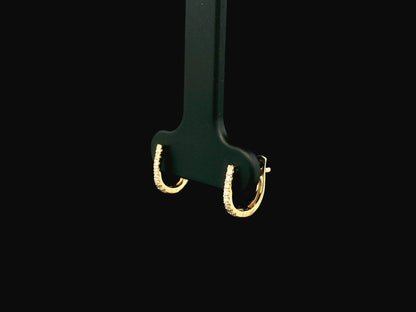 18K yellow gold diamond huggie hoop earrings featuring 0.09 carats of natural diamonds in a classic everyday hoop design.