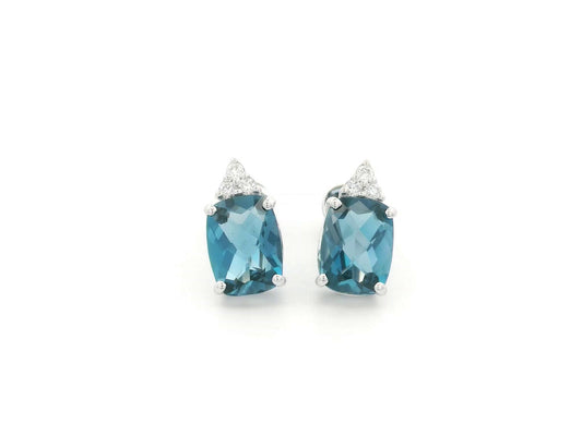18K white gold London Blue Topaz stud earrings featuring 2.94 carats of cushion cut London Blue Topaz with diamond accents