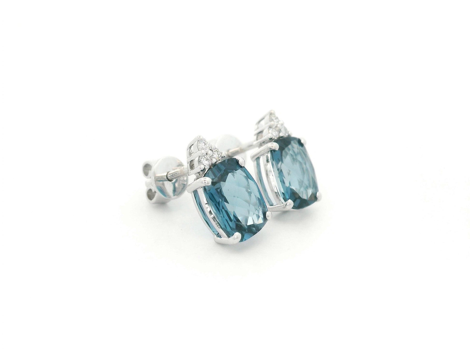 18K white gold London Blue Topaz stud earrings featuring 2.94 carats of cushion cut London Blue Topaz with diamond accents