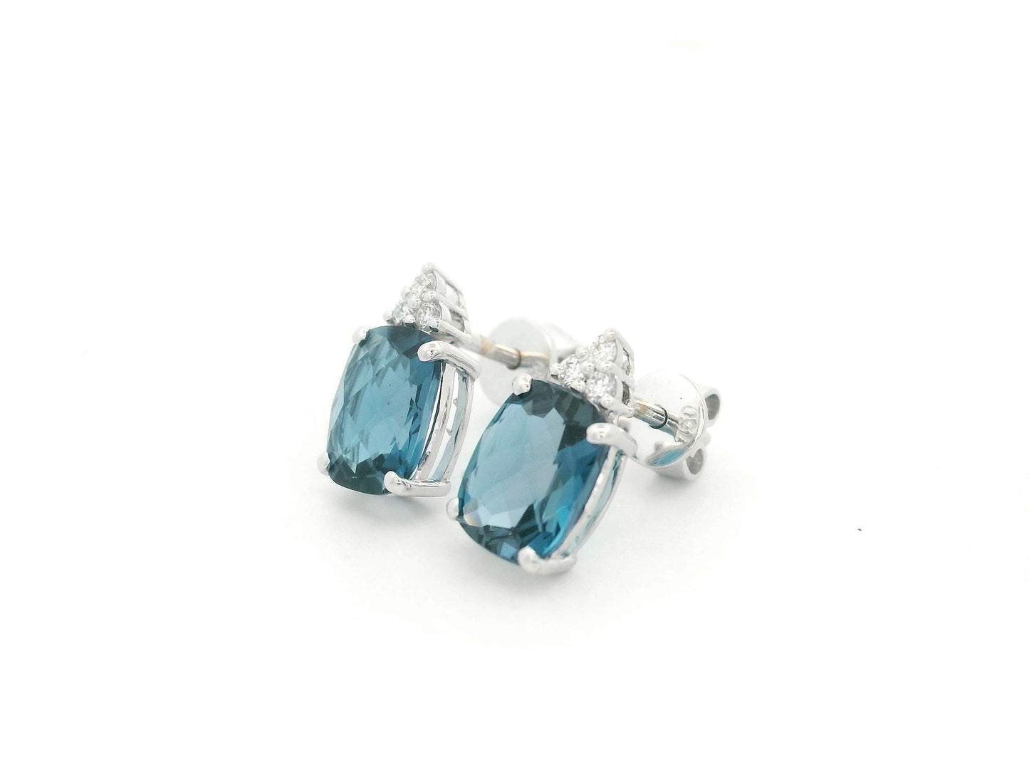 18K white gold London Blue Topaz stud earrings featuring 2.94 carats of cushion cut London Blue Topaz with diamond accents
