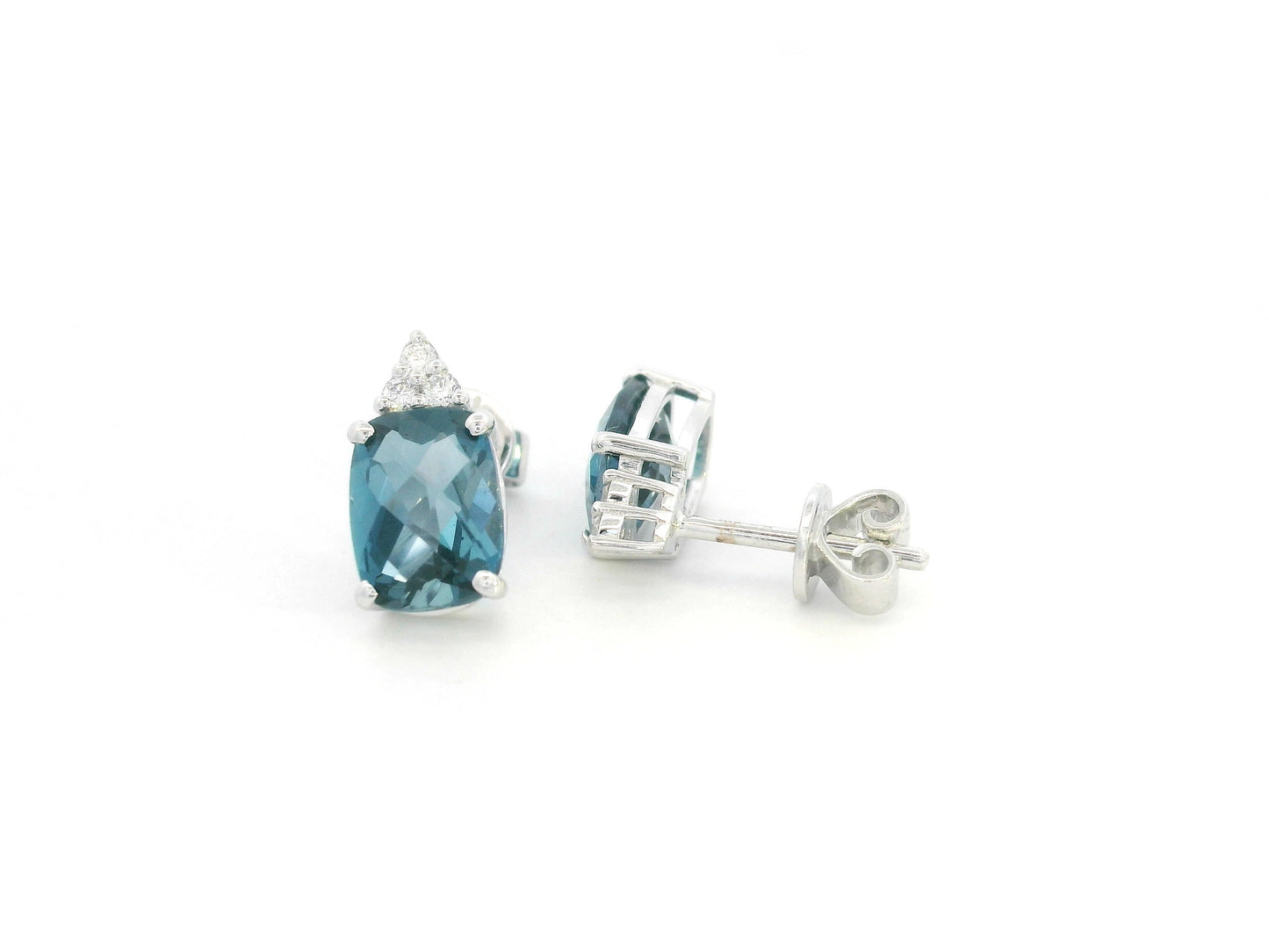 18K white gold London Blue Topaz stud earrings featuring 2.94 carats of cushion cut London Blue Topaz with diamond accents