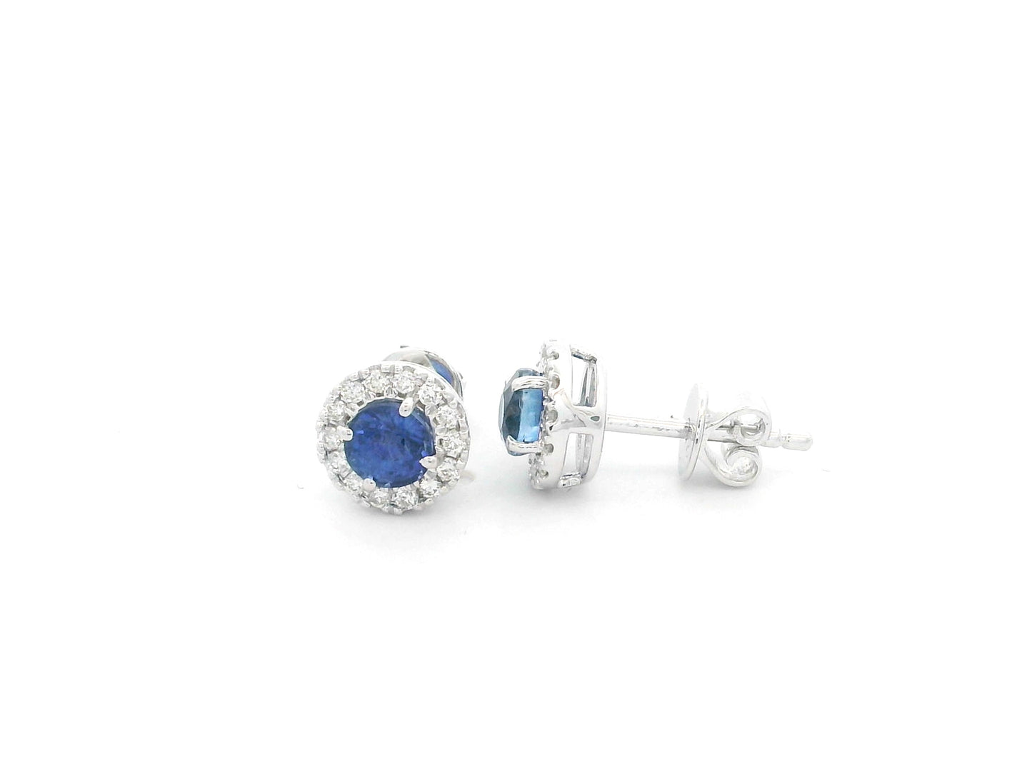 18K white gold sapphire halo stud earrings featuring 1.06 carats of blue sapphires surrounded by 0.16 carats of natural diamonds.
