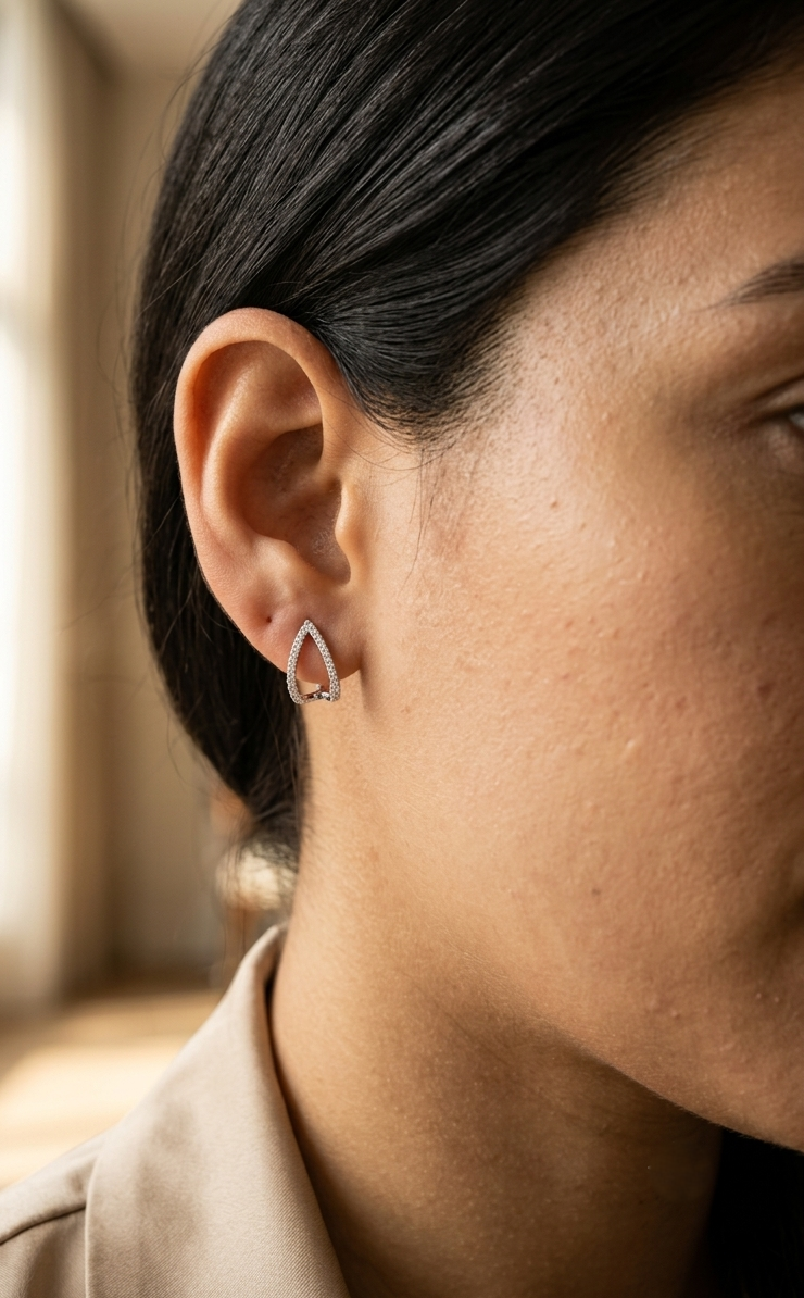18K white gold diamond teardrop earrings featuring 0.25 carat natural diamonds in an elegant open teardrop design with butterfly push back closures.