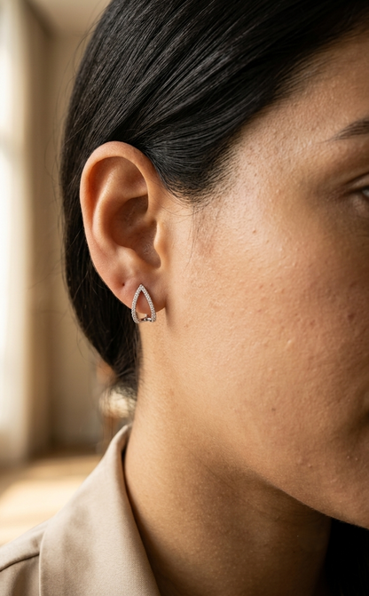 18K white gold diamond teardrop earrings featuring 0.25 carat natural diamonds in an elegant open teardrop design with butterfly push back closures.