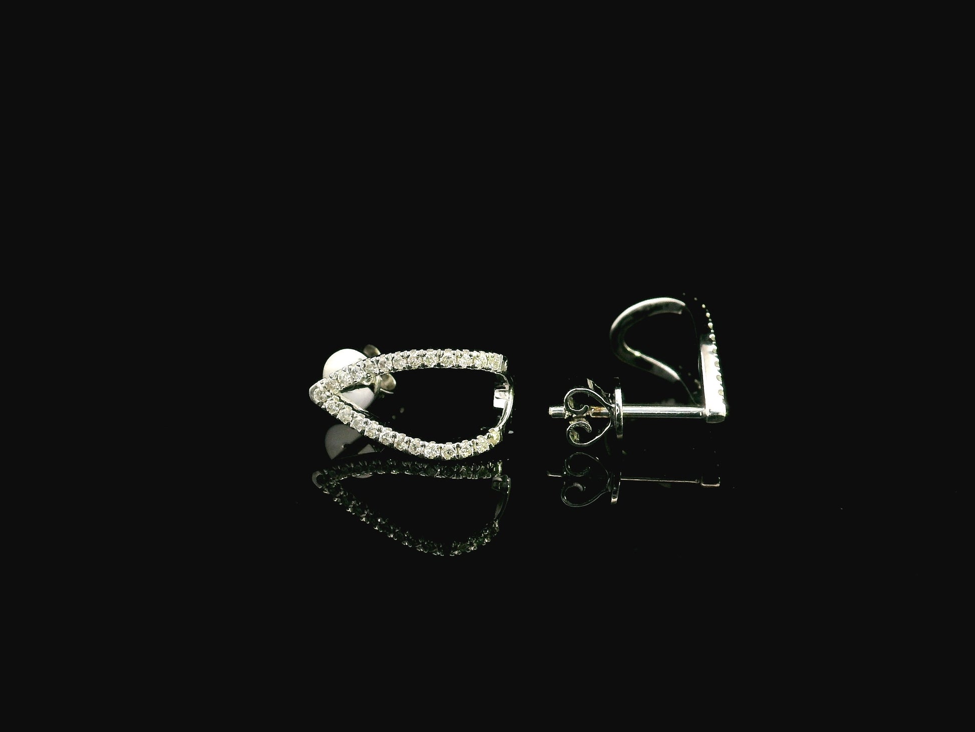 18K white gold diamond teardrop earrings featuring 0.25 carat natural diamonds in an elegant open teardrop design with butterfly push back closures.