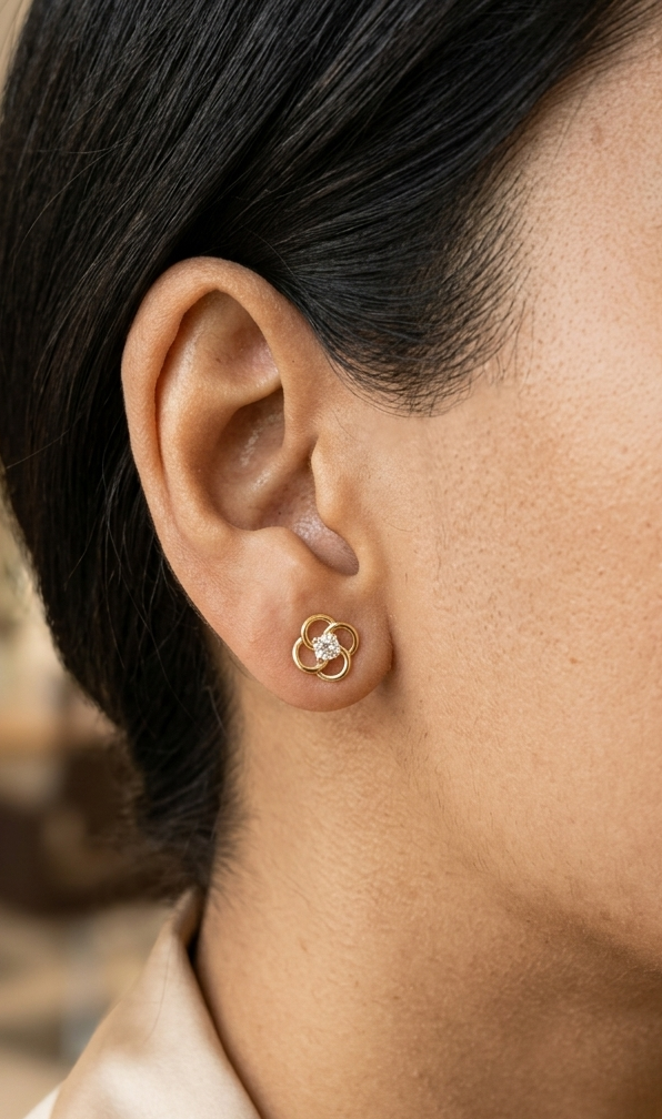 18K yellow gold diamond flower stud earrings featuring an open floral design with 0.19 carats of natural round brilliant diamonds and secure butterfly backs.