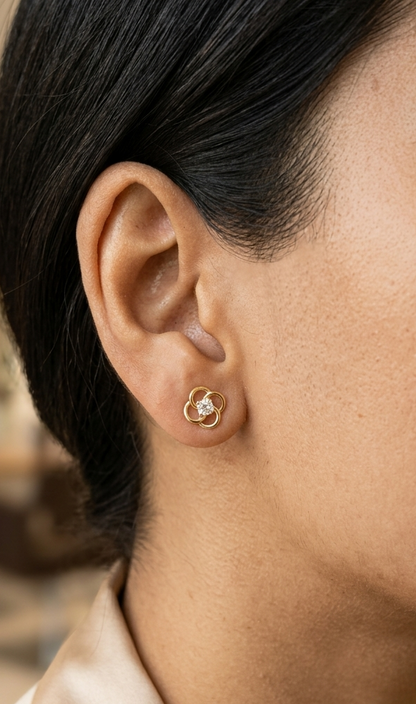 18K yellow gold diamond flower stud earrings featuring an open floral design with 0.19 carats of natural round brilliant diamonds and secure butterfly backs.