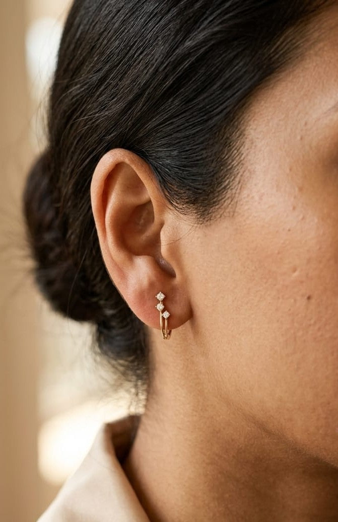 18K Yellow Gold Diamond Hoop Earrings featuring three natural diamonds on each hoop with a modern double-row huggie design.