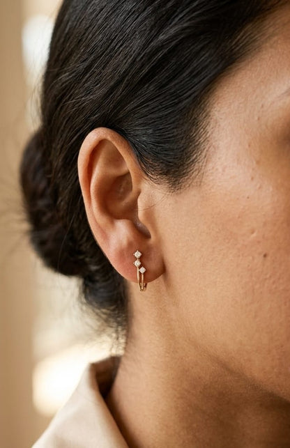 18K Yellow Gold Diamond Hoop Earrings featuring three natural diamonds on each hoop with a modern double-row huggie design.
