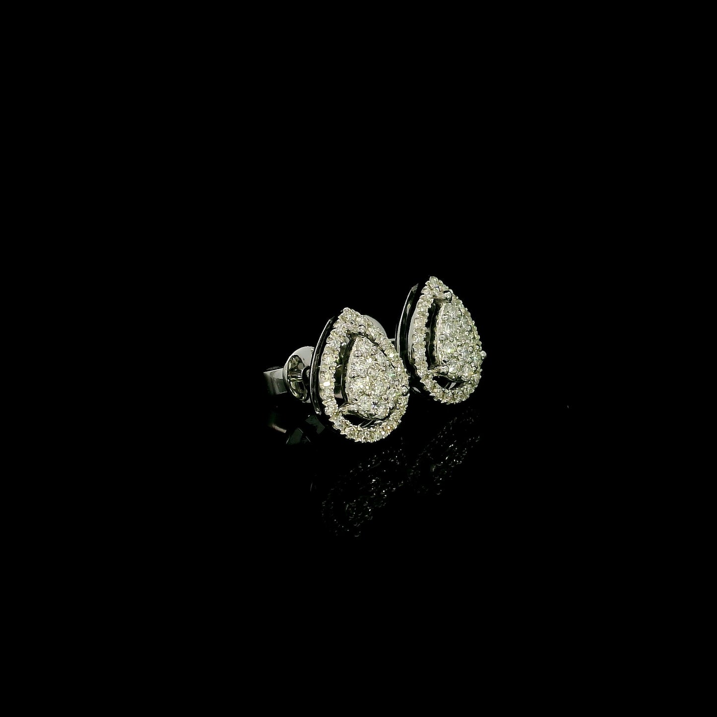18K white gold diamond stud earrings featuring a pear-shaped cluster of natural diamonds surrounded by a sparkling diamond halo.