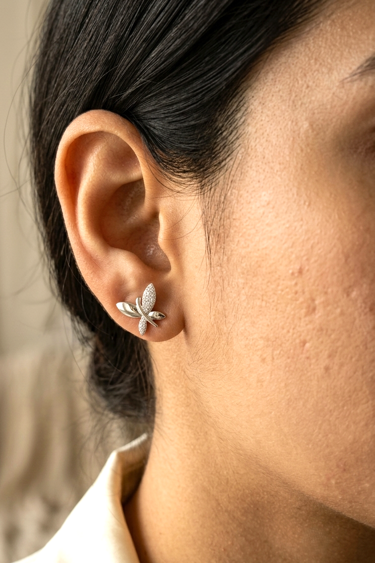 18K white gold butterfly stud earrings featuring 0.24 carat natural round brilliant diamonds with polished white gold wings.