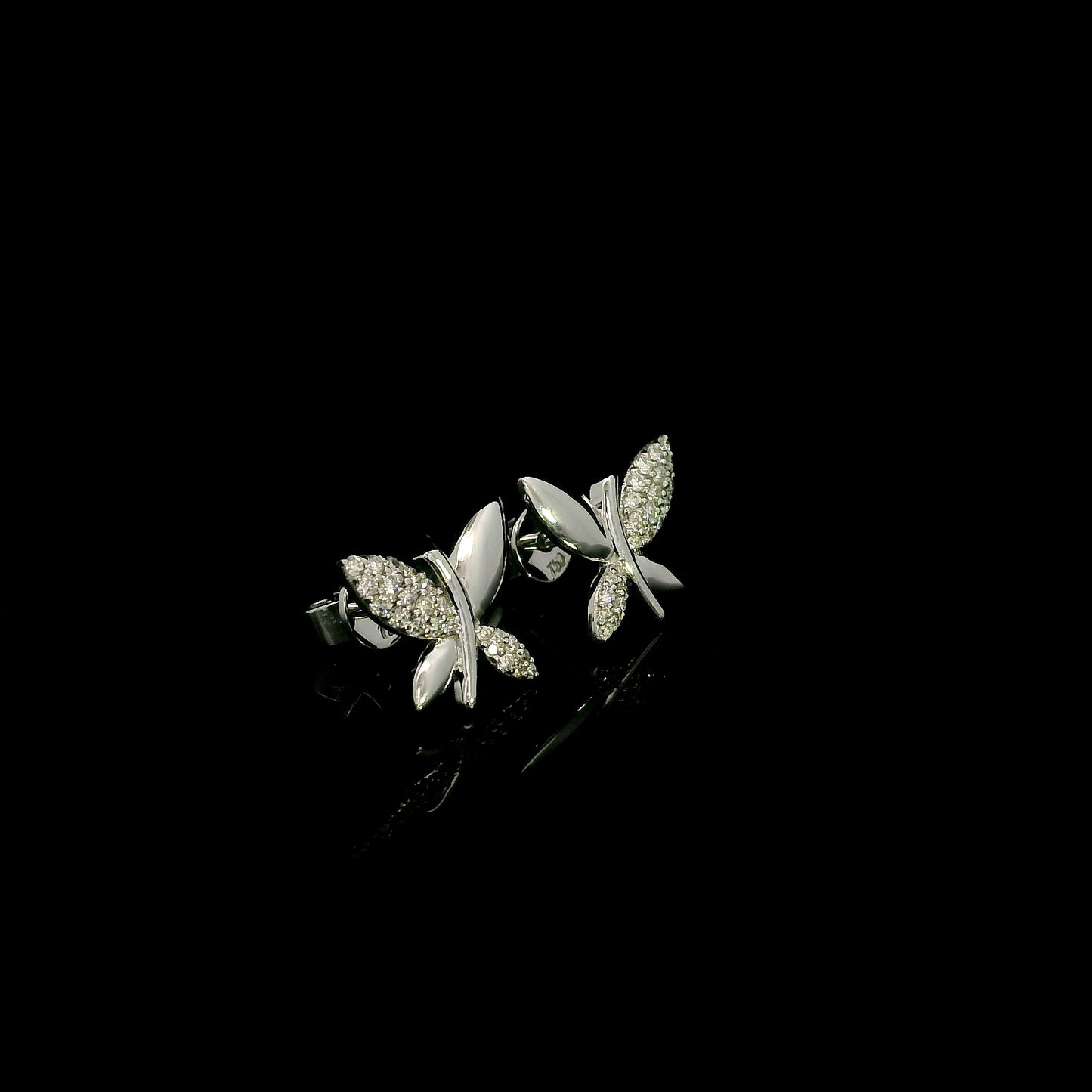 18K white gold butterfly stud earrings featuring 0.24 carat natural round brilliant diamonds with polished white gold wings.