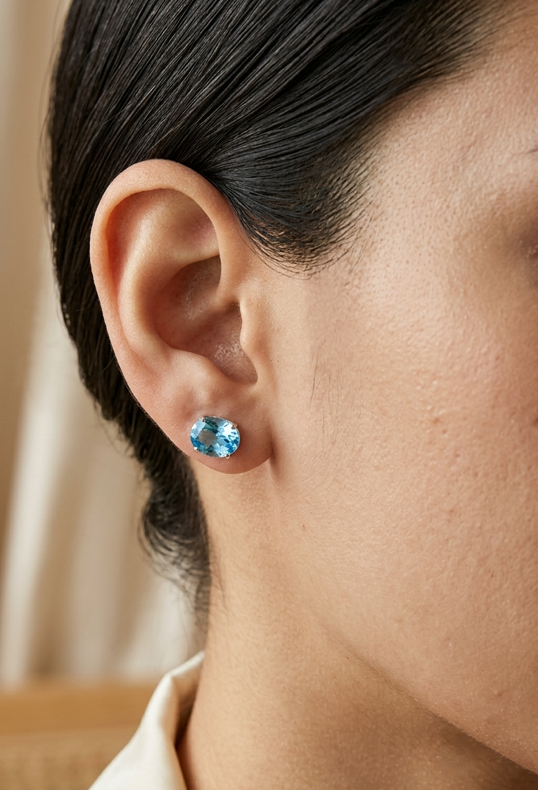 18K white gold Swiss Blue Topaz stud earrings featuring round natural Swiss Blue Topaz gemstones with a total weight of 3.75 carats in classic four-prong settings.