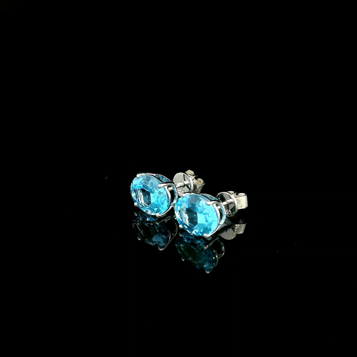 18K white gold Swiss Blue Topaz stud earrings featuring round natural Swiss Blue Topaz gemstones with a total weight of 3.75 carats in classic four-prong settings.