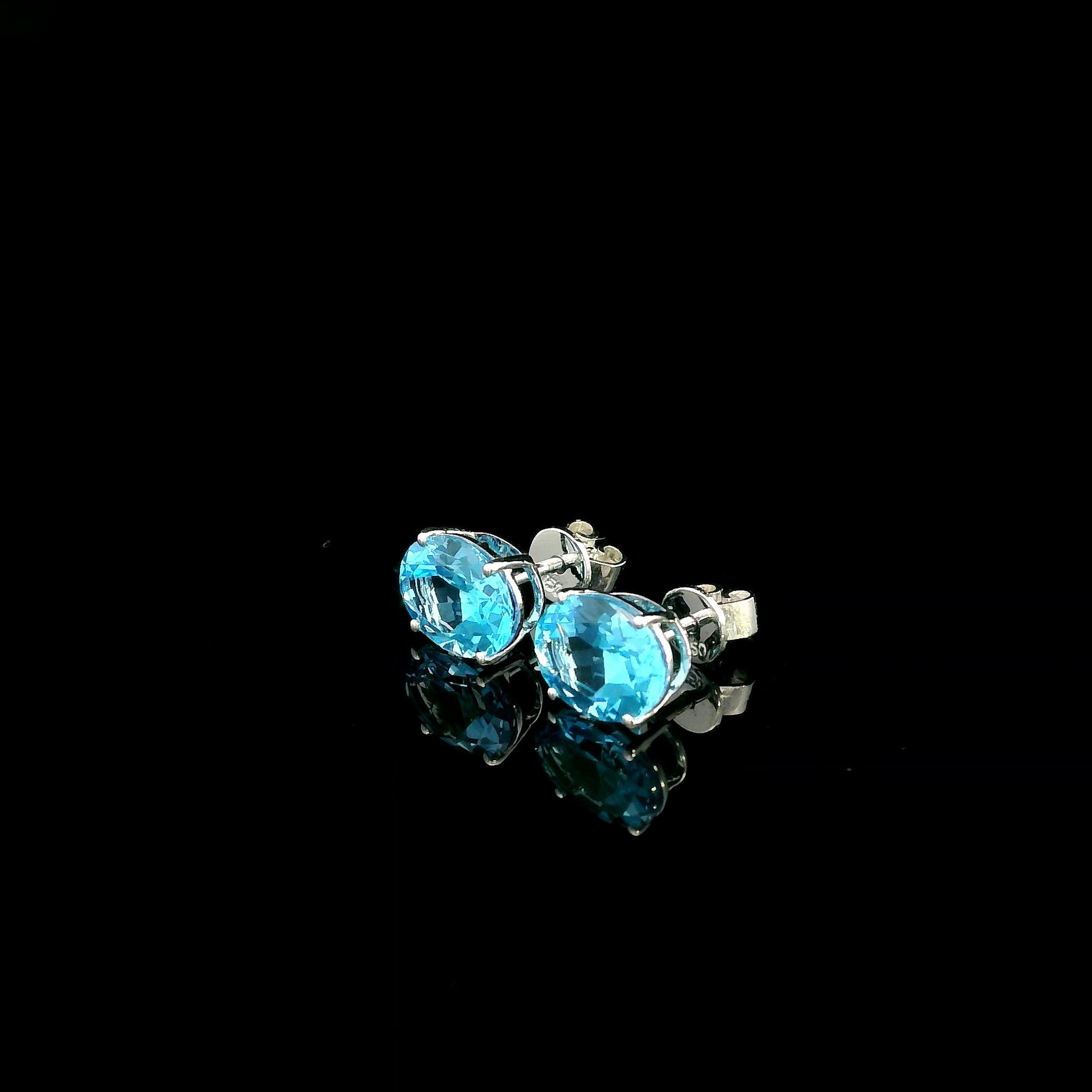 18K white gold Swiss Blue Topaz stud earrings featuring round natural Swiss Blue Topaz gemstones with a total weight of 3.75 carats in classic four-prong settings.