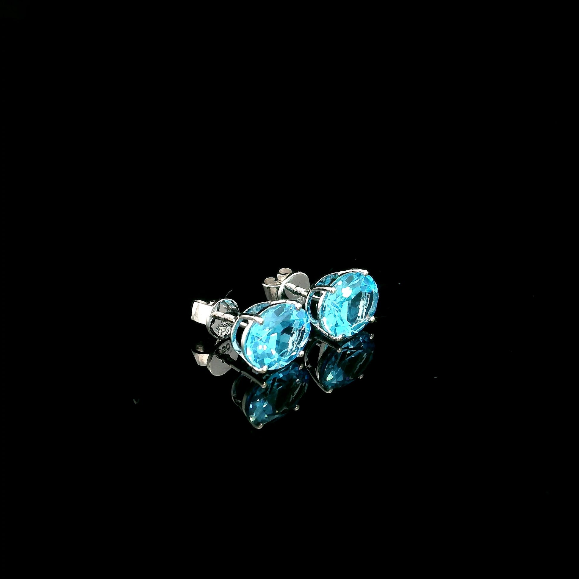 18K white gold Swiss Blue Topaz stud earrings featuring round natural Swiss Blue Topaz gemstones with a total weight of 3.75 carats in classic four-prong settings.