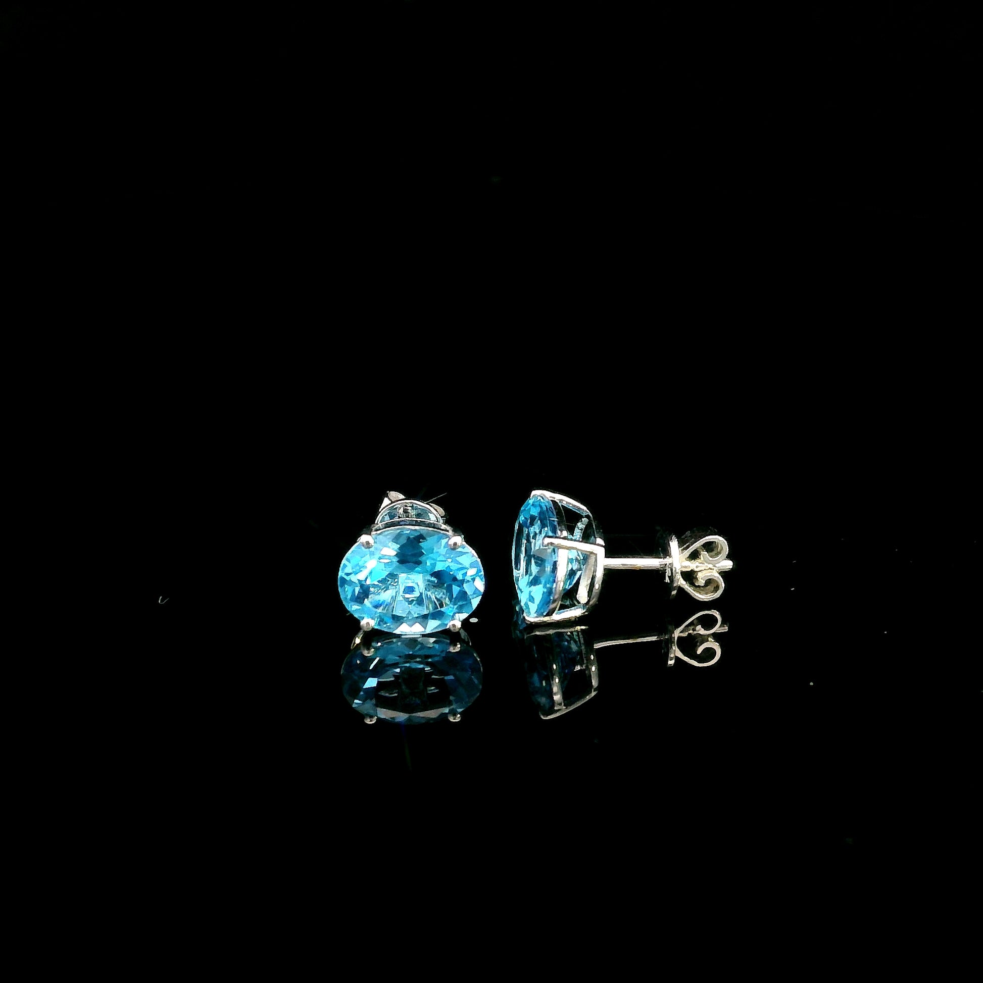 18K white gold Swiss Blue Topaz stud earrings featuring round natural Swiss Blue Topaz gemstones with a total weight of 3.75 carats in classic four-prong settings.