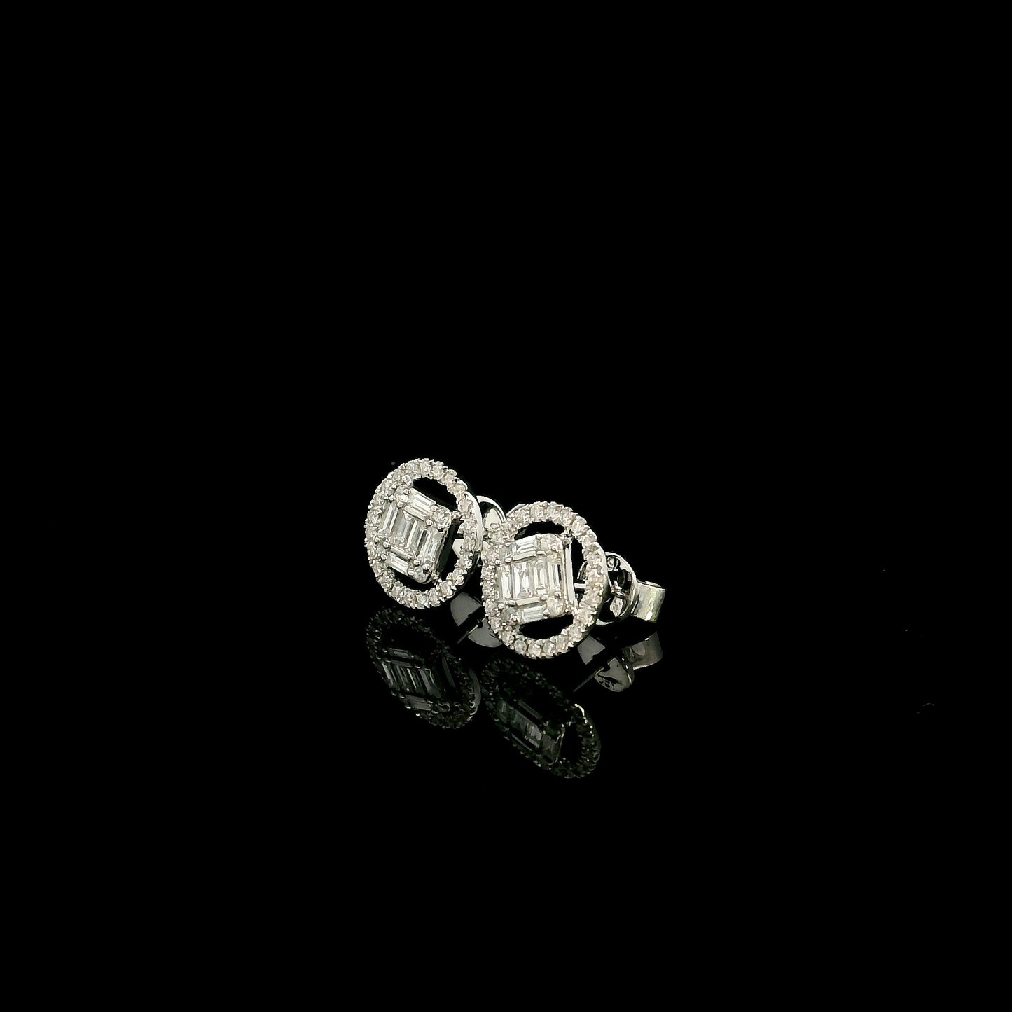 18K white gold emerald cut illusion diamond stud earrings featuring round and baguette natural diamonds with a sparkling round diamond halo and secure butterfly backs.