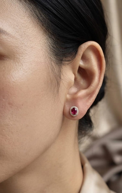 18K yellow gold natural ruby diamond halo stud earrings featuring round rubies surrounded by brilliant natural diamonds.