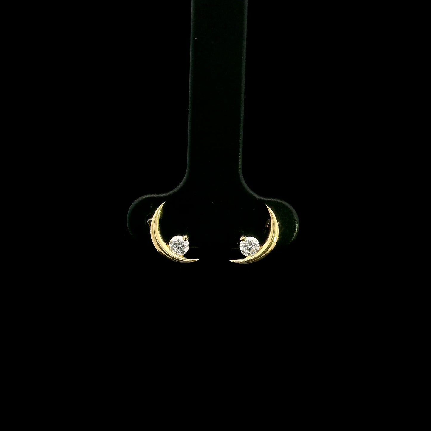 18K yellow gold crescent moon stud earrings featuring 0.17 carat natural round brilliant diamonds with secure butterfly push backs.