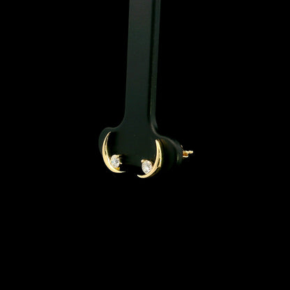 18K yellow gold crescent moon stud earrings featuring 0.17 carat natural round brilliant diamonds with secure butterfly push backs.