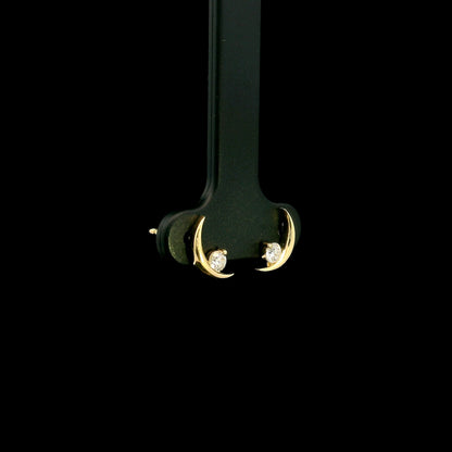 18K yellow gold crescent moon stud earrings featuring 0.17 carat natural round brilliant diamonds with secure butterfly push backs.