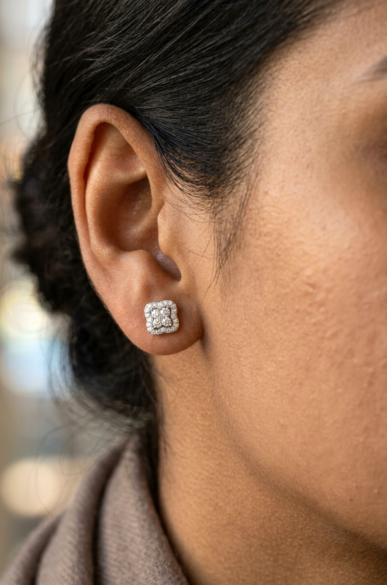 18K white gold cushion halo diamond stud earrings featuring 0.44 carat natural round brilliant diamonds in a sparkling cluster design with secure butterfly backs.