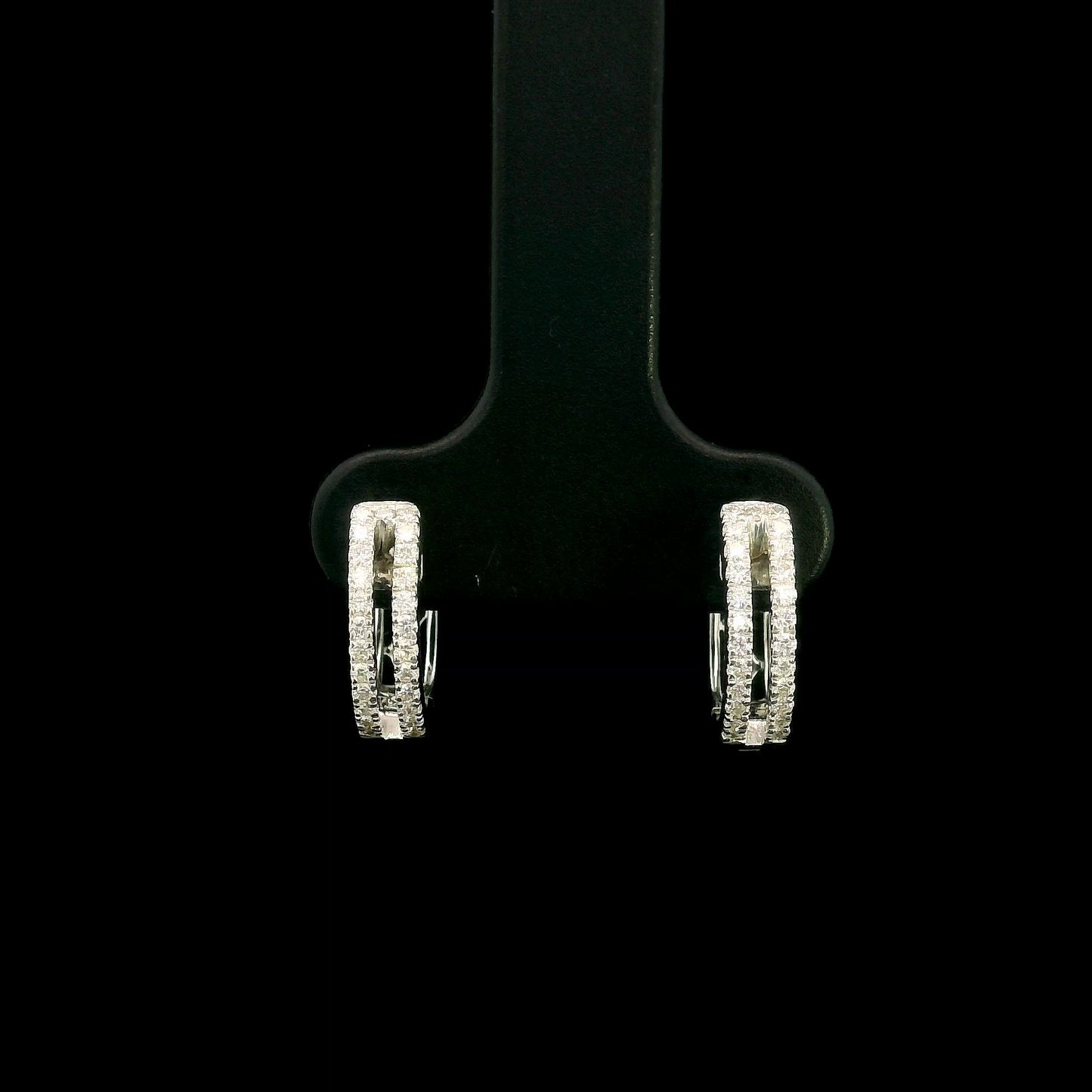 18K white gold diamond huggie hoop earrings featuring 0.23 carat natural round brilliant pavé-set diamonds in a modern double-row design with a secure hinged closure.