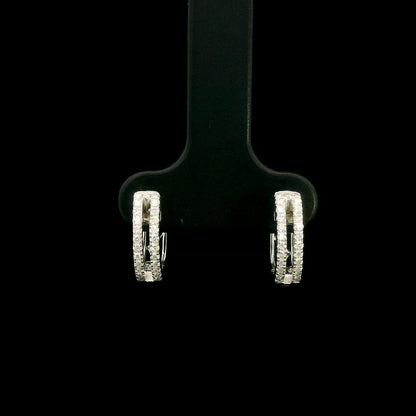 18K white gold diamond huggie hoop earrings featuring 0.23 carat natural round brilliant pavé-set diamonds in a modern double-row design with a secure hinged closure.
