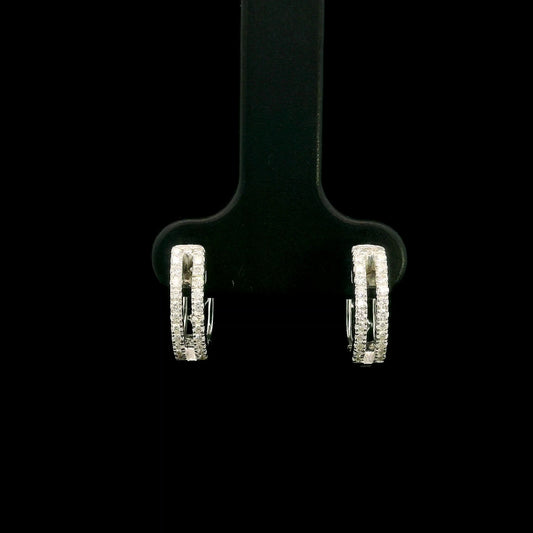 18K white gold diamond huggie hoop earrings featuring 0.23 carat natural round brilliant pavé-set diamonds in a modern double-row design with a secure hinged closure.