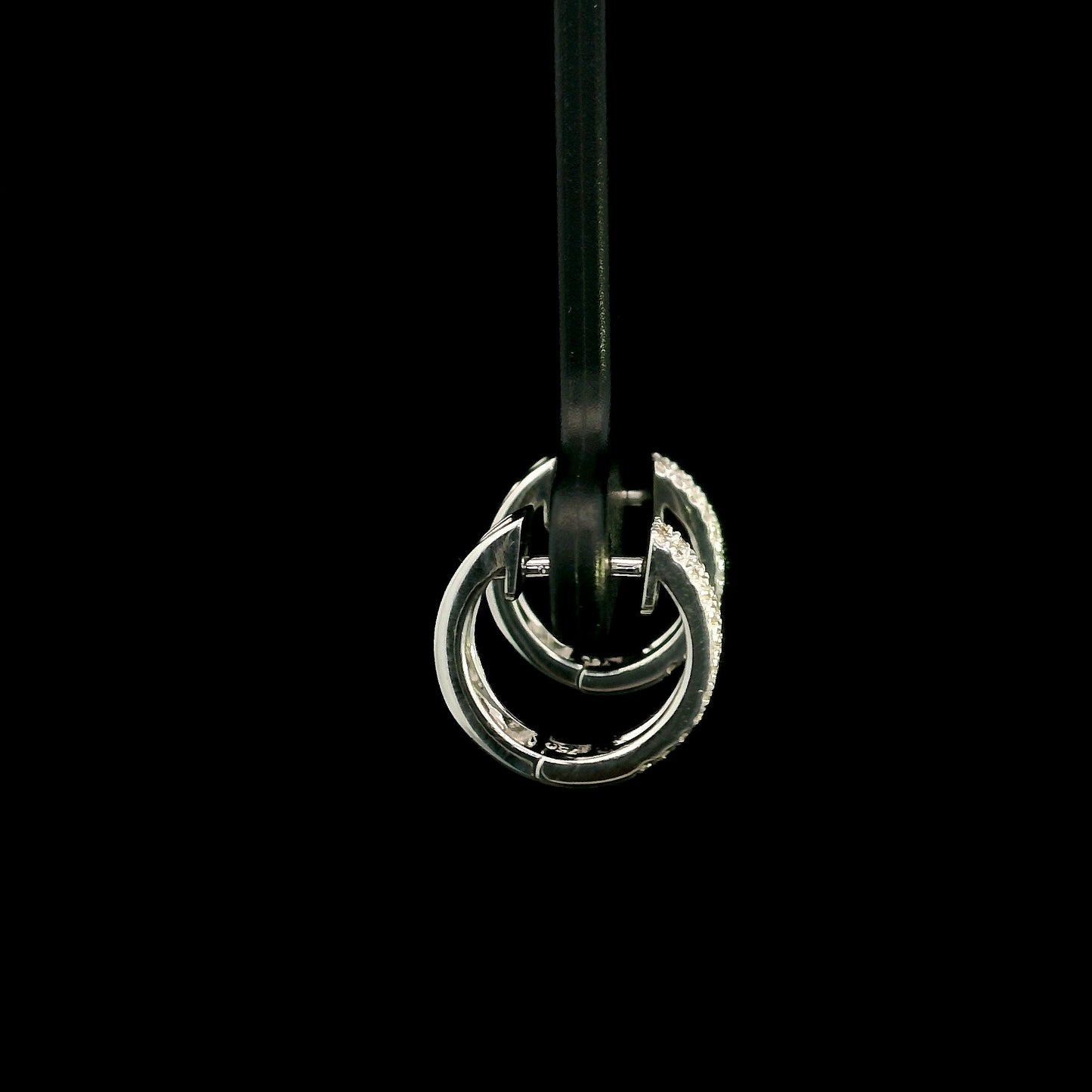 18K white gold diamond huggie hoop earrings featuring 0.23 carat natural round brilliant pavé-set diamonds in a modern double-row design with a secure hinged closure.