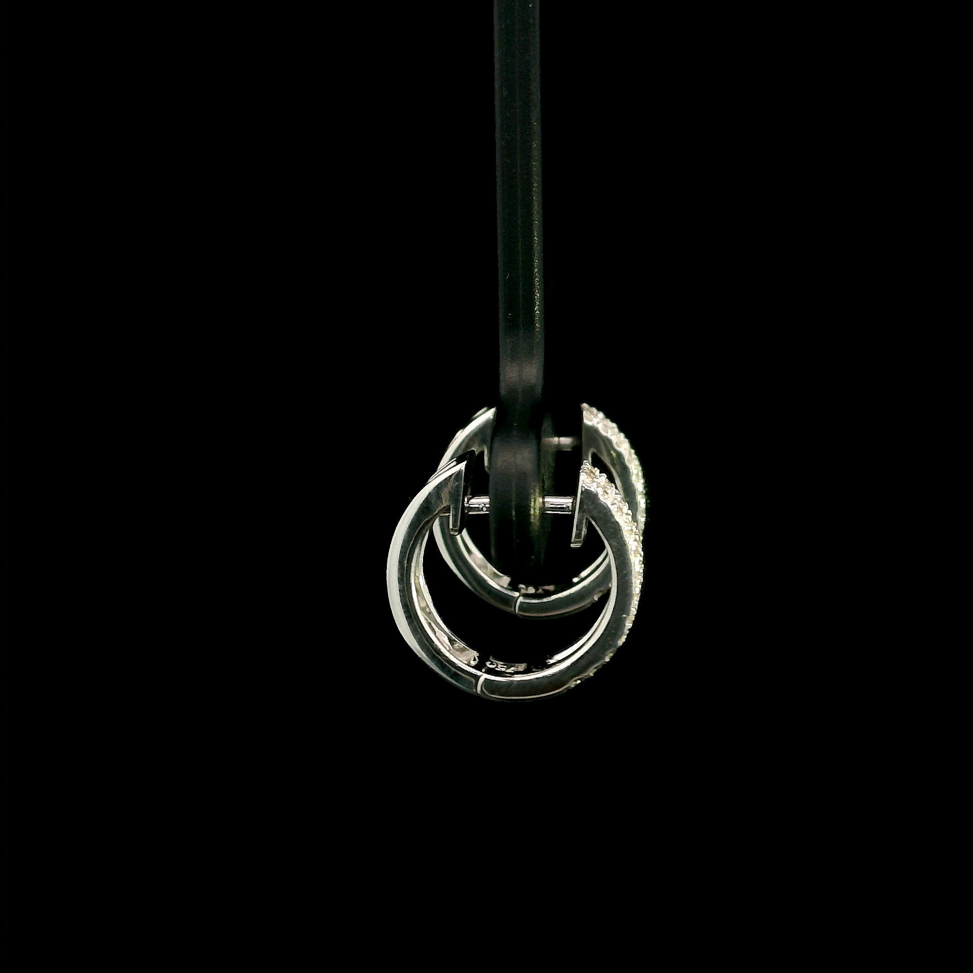 18K white gold diamond huggie hoop earrings featuring 0.23 carat natural round brilliant pavé-set diamonds in a modern double-row design with a secure hinged closure.