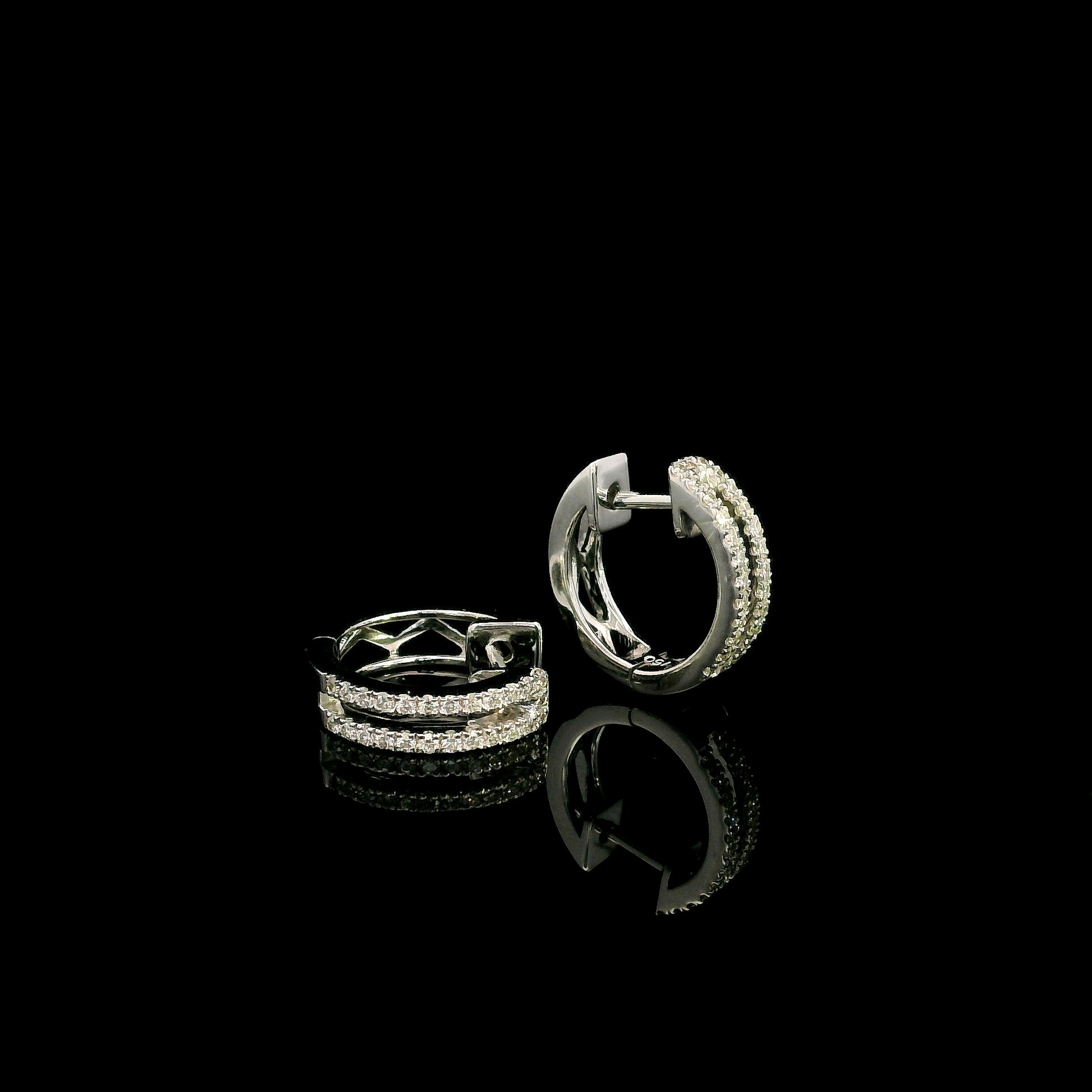 18K white gold diamond huggie hoop earrings featuring 0.23 carat natural round brilliant pavé-set diamonds in a modern double-row design with a secure hinged closure.