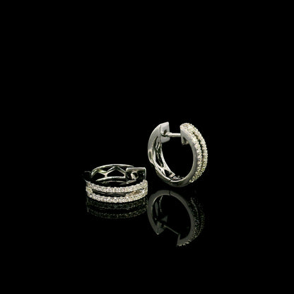 18K white gold diamond huggie hoop earrings featuring 0.23 carat natural round brilliant pavé-set diamonds in a modern double-row design with a secure hinged closure.