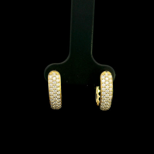 18K yellow gold diamond huggie hoop earrings featuring 0.51 carat natural round brilliant pavé-set diamonds with a secure hinged closure.