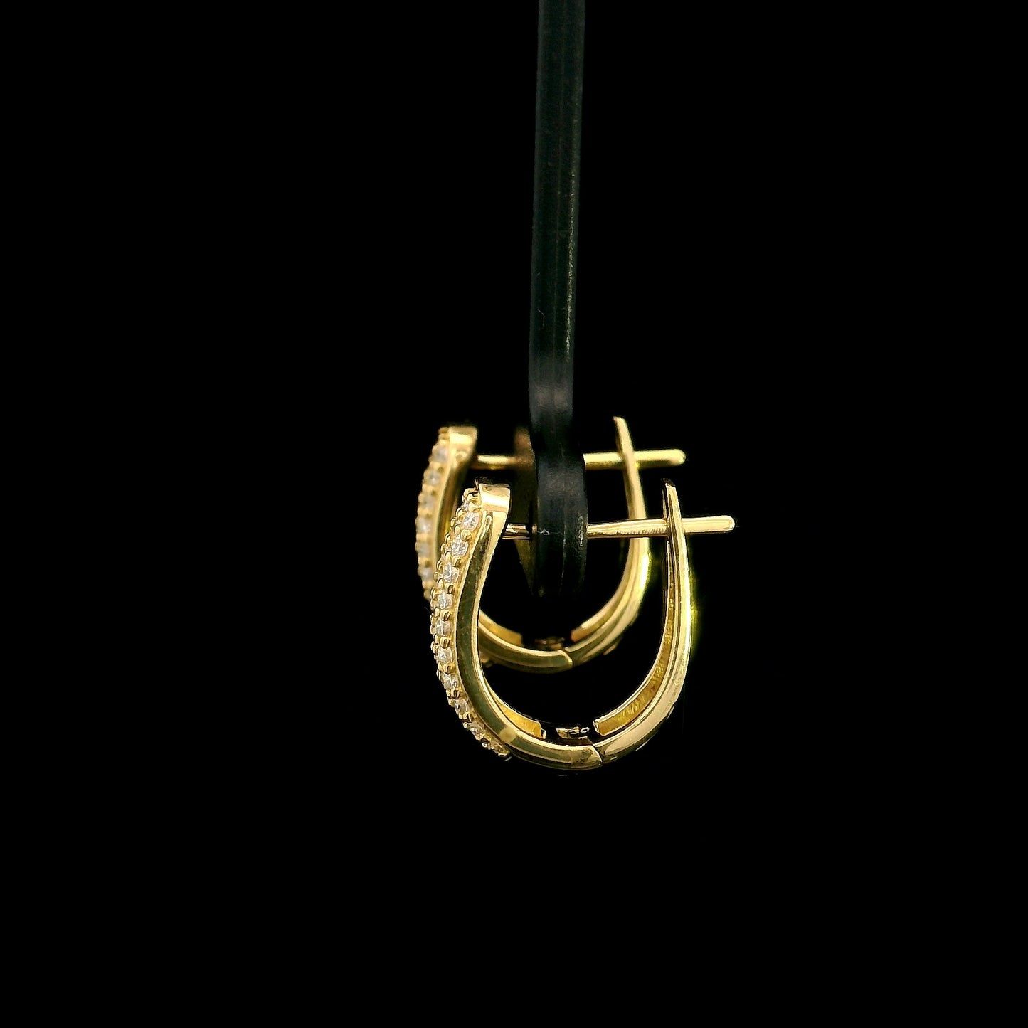 18K yellow gold diamond huggie hoop earrings featuring 0.51 carat natural round brilliant pavé-set diamonds with a secure hinged closure.