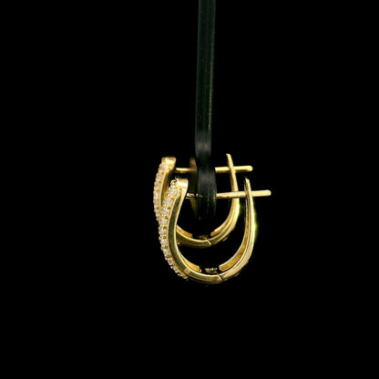 18K yellow gold diamond huggie hoop earrings featuring 0.51 carat natural round brilliant pavé-set diamonds with a secure hinged closure.