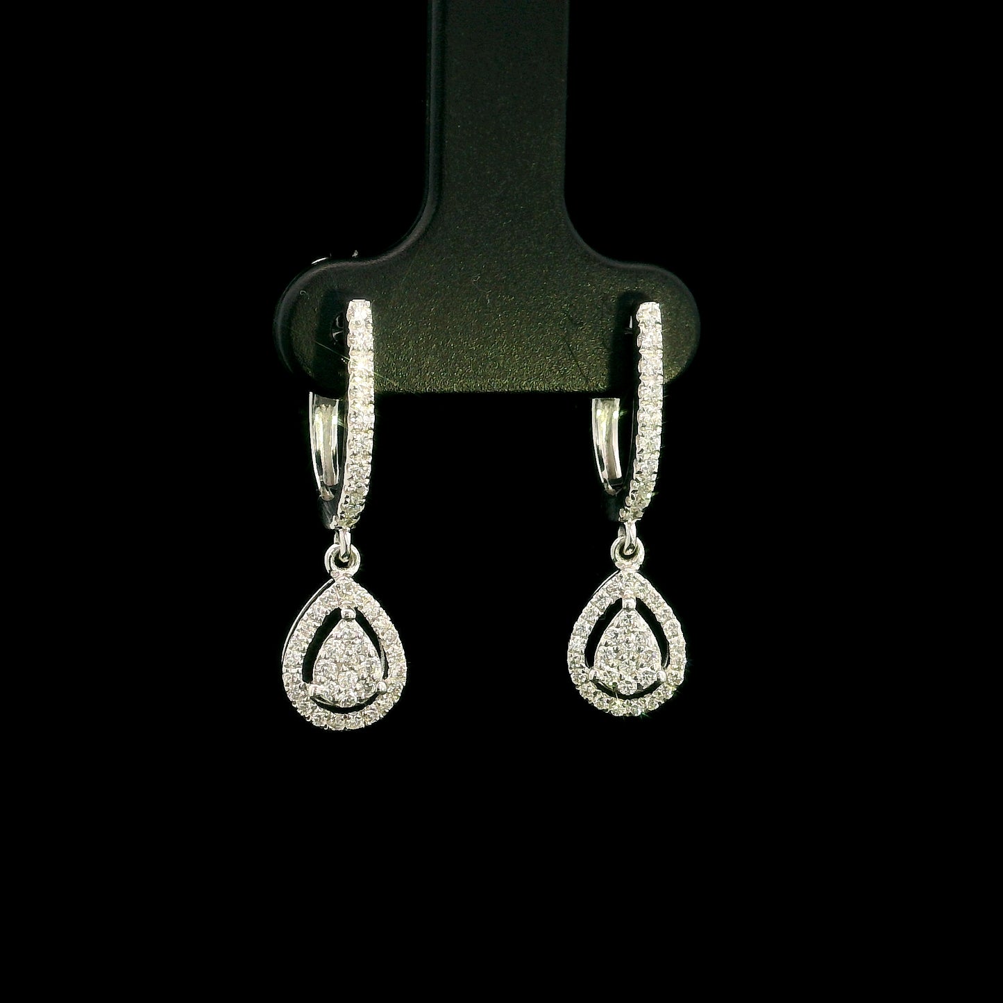 18K white gold pear diamond drop earrings featuring 0.44 carat natural diamonds with diamond-set huggie hoops and open pear halo design.