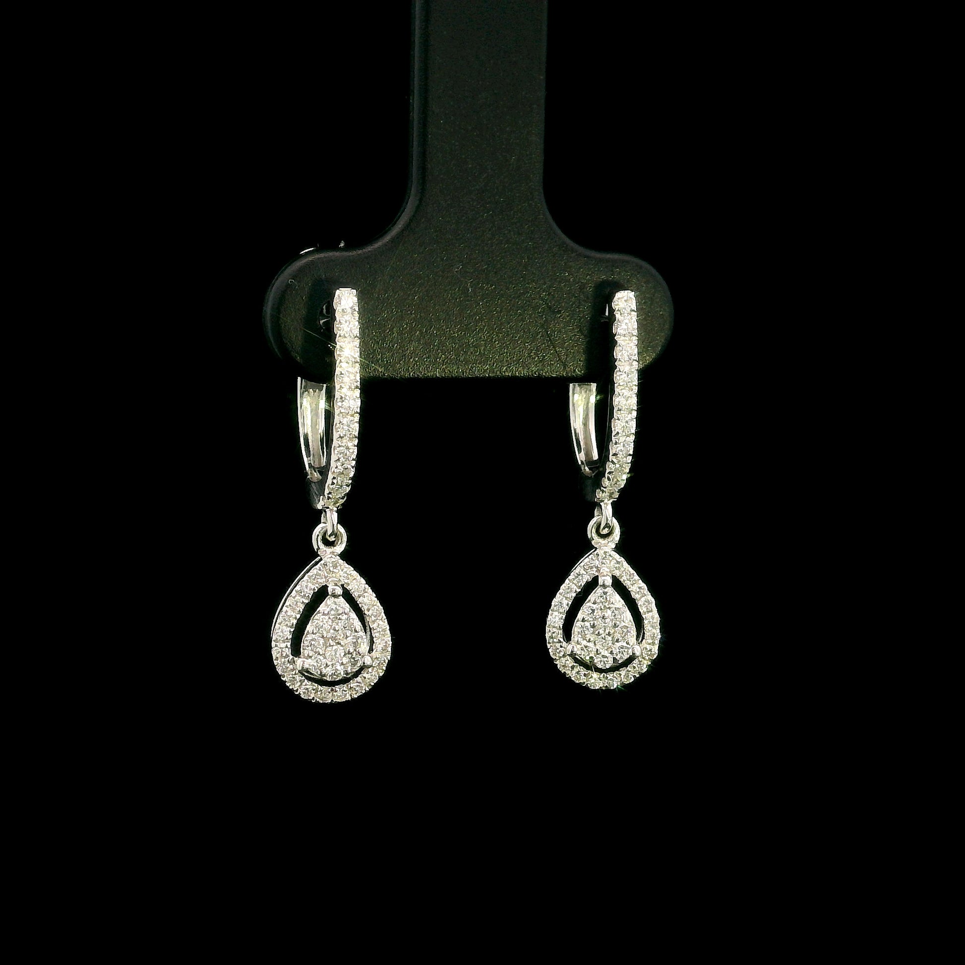 18K white gold pear diamond drop earrings featuring 0.44 carat natural diamonds with diamond-set huggie hoops and open pear halo design.
