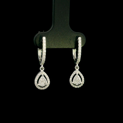 18K white gold pear diamond drop earrings featuring 0.44 carat natural diamonds with diamond-set huggie hoops and open pear halo design.