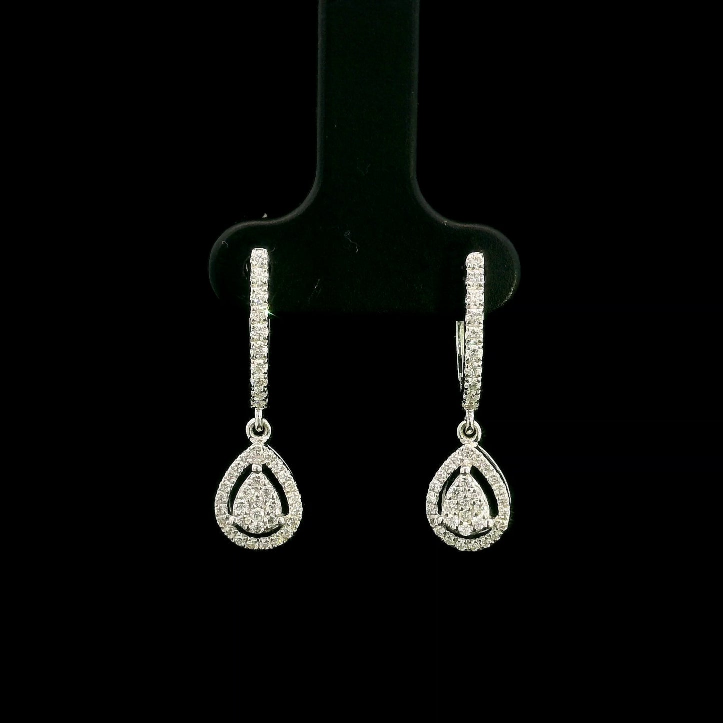 18K white gold pear diamond drop earrings featuring 0.44 carat natural diamonds with diamond-set huggie hoops and open pear halo design.