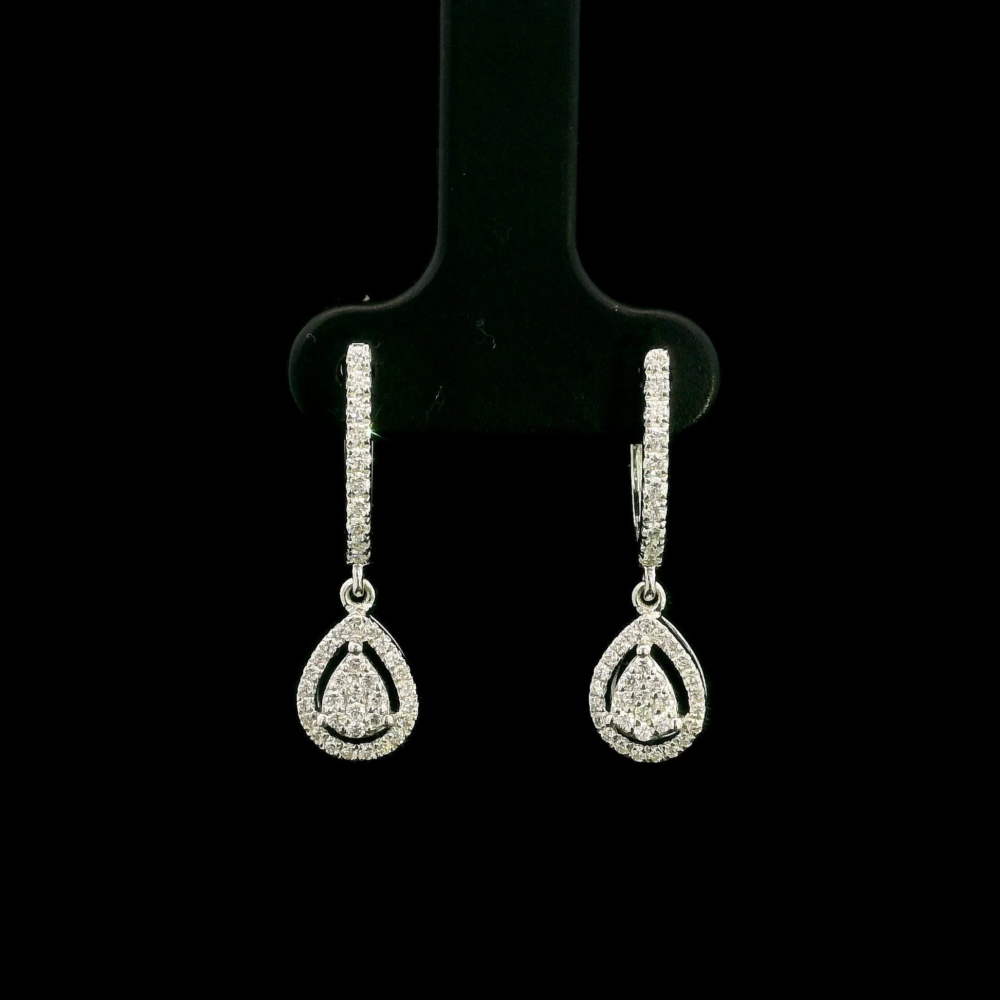 18K white gold pear diamond drop earrings featuring 0.44 carat natural diamonds with diamond-set huggie hoops and open pear halo design.