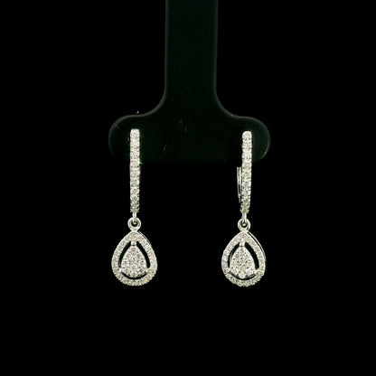 18K white gold pear diamond drop earrings featuring 0.44 carat natural diamonds with diamond-set huggie hoops and open pear halo design.