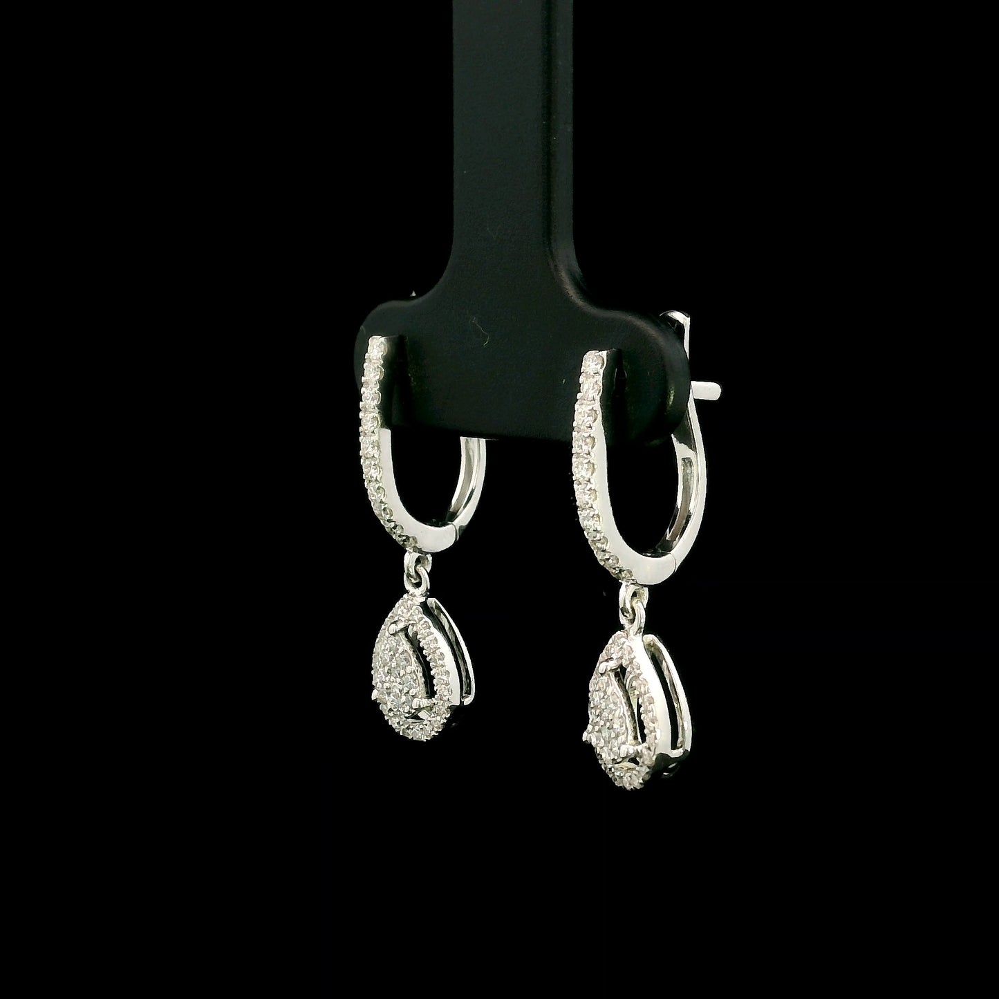 18K white gold pear diamond drop earrings featuring 0.44 carat natural diamonds with diamond-set huggie hoops and open pear halo design.