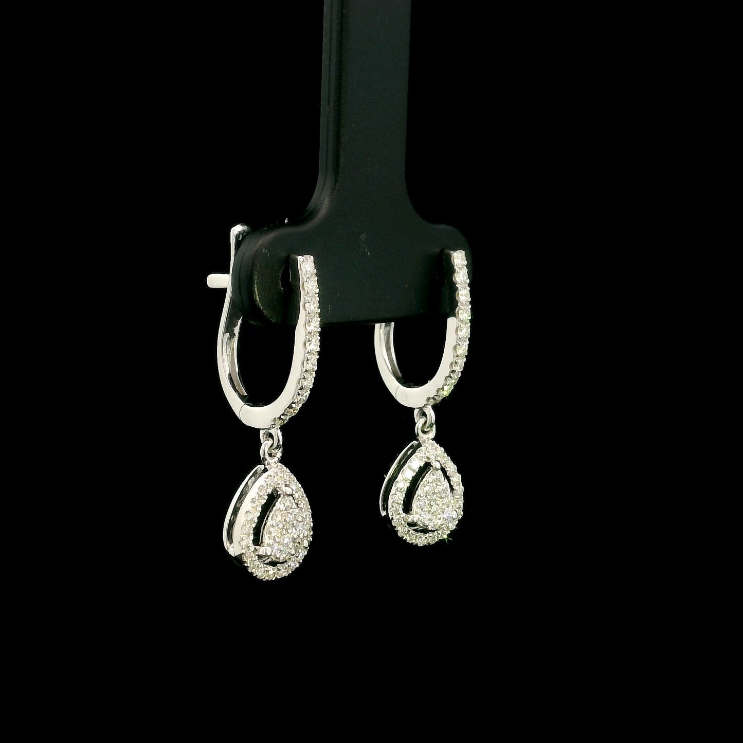 18K white gold pear diamond drop earrings featuring 0.44 carat natural diamonds with diamond-set huggie hoops and open pear halo design.