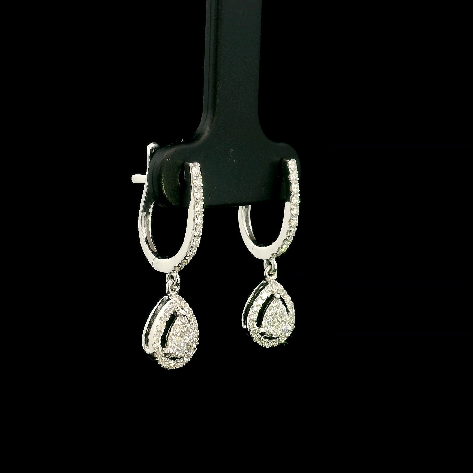 18K white gold pear diamond drop earrings featuring 0.44 carat natural diamonds with diamond-set huggie hoops and open pear halo design.