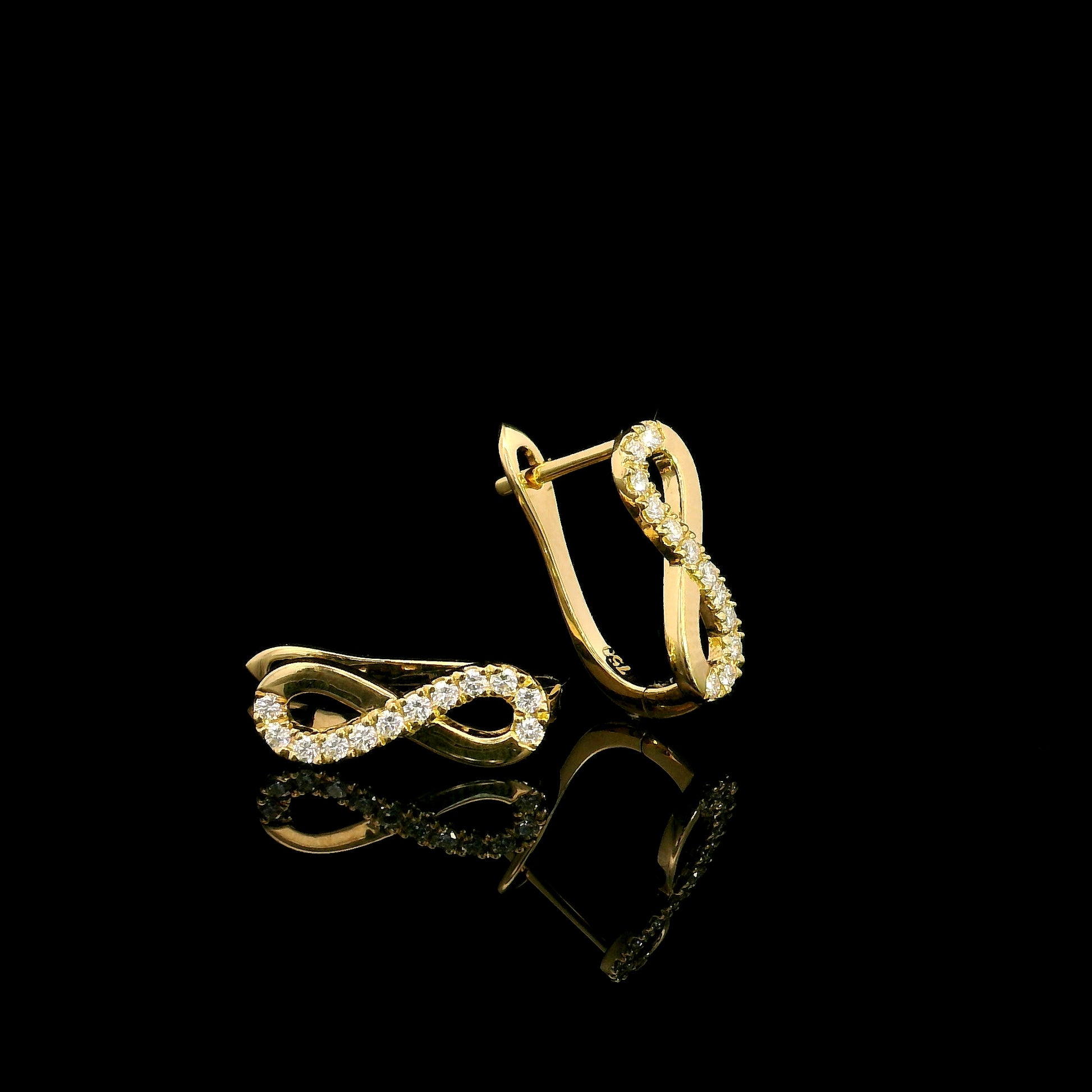 18K yellow gold infinity diamond earrings featuring natural round brilliant diamonds in a pavé setting with a total diamond weight of 0.22 carat.