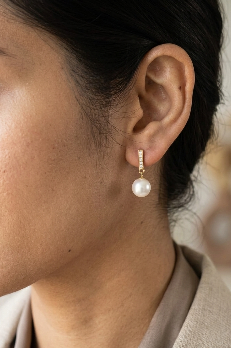 Freshwater pearl and diamond drop earrings in 18K yellow gold with diamond-set bar detail