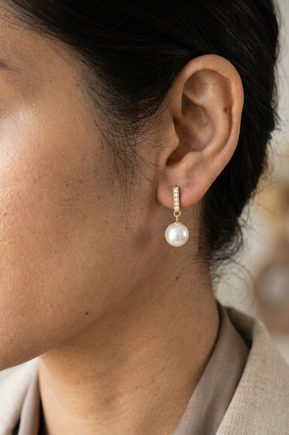 Freshwater pearl and diamond drop earrings in 18K yellow gold with diamond-set bar detail