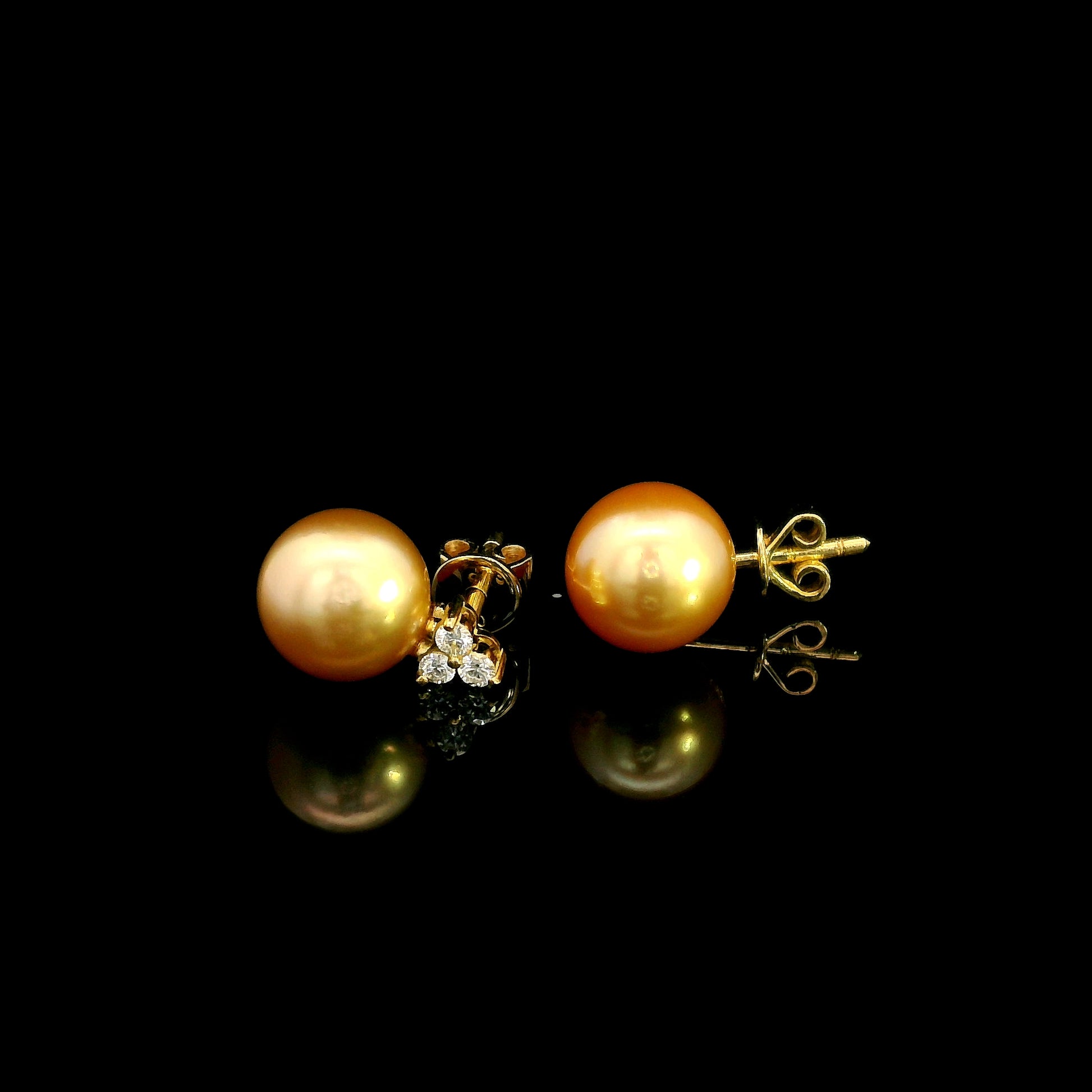 South Sea golden pearl and diamond stud earrings in 18K yellow gold with 8 x 8.5 mm pearls and three-diamond accents